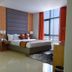 Meshal Hotel & Spa in Manama guest room with king bed, floor-to-ceiling window, and mirrored wardrobe