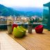 Brizo Salta rooftop terrace with colorful chairs and mountain city views in Salta