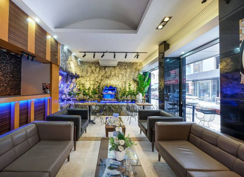 Marlight Boutique Hotel Izmir lobby lounge with seating, bar, and greenery wall