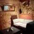 eXo Hotel Franka Bamberg in Hallstadt: rustic lounge with sofa, coffee table, stone walls and brick accent