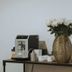 Travelers Orange Suites in Medellín breakfast station with coffee machine, flowers, and fruit-infused water