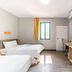 7 Days Inn Guangzhou Beijing Road Metro Branch room with two beds, wall-mounted TV, desk and window