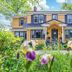 The Stella Rose B&B in Wolfville, yellow house exterior with landscaped garden and front porch
