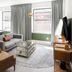 Sosuite at French Quarters - Rittenhouse Square in Philadelphia living room with sofa, chair, desk and windows