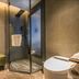 Puruihotel Yongkang in Jinhua bathroom with glass shower, towel rack, and white toilet