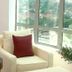 Oriental Crystal Hotel in Kajang lounge with white armchair, red pillow, and city views through large windows