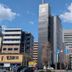GR Hotel Ginzadori tower in Kumamoto along a city street under a blue sky