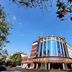 Wuyue Yuexin Hotel (Jinggangshan) in Ji'an with a curved glass facade under a blue sky