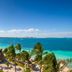 Fiesta Americana Cancun Villas in Cancún with oceanfront pool, palm trees, and turquoise sea view