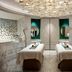 Waldorf Astoria Ras Al Khaimah spa treatment room with two massage tables and ornate ceiling