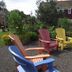 Bailey House in Annapolis Royal with colorful Adirondack chairs in a gravel garden overlooking the water