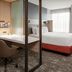 SpringHill Suites by Marriott Beaufort guest room with desk, bed and large window