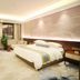 Anhui Construction New Era Hotel in Bengbu guest room with king bed, TV, balcony door and modern decor