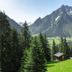 Familienhotel Mateera Gargellen in Montafon overlooking a green alpine valley and mountain peak