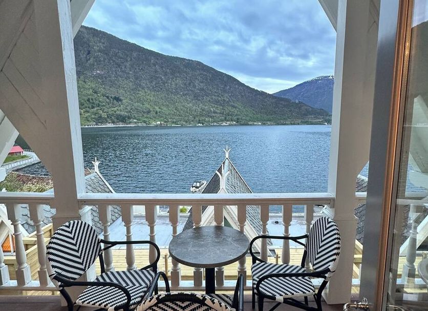 Hofslund Fjord Hotel in Sogndal balcony seating with fjord and mountain view