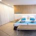 Servatur Playa Bonita in Maspalomas: bright guest room with twin beds and a bench