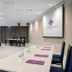 Hotel Salona Palace in Solin meeting room with conference table, chairs, and presentation screen