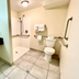Red Carpet Inn - New Brunswick bathroom with sink vanity, toilet, grab bars and roll-in shower