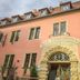 Hotel Vier Jahreszeiten in Volkach exterior with ornate arched entrance and pink facade