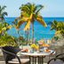 Bahia Del Duque Adeje terrace dining with palm trees and ocean view