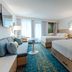 Howard Johnson by Wyndham Anaheim Hotel & Water Playground guest room with two beds and sofa in Anaheim