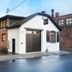 Dye House in Providence, brick-and-white exterior of the hotel building on a wet street