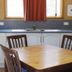 Mount Rumney Escapes - Platypus Cabin kitchen with dining table and chairs in Cambridge