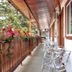 Gateway Motel in Radium Hot Springs: flower-lined covered outdoor walkway with metal chairs