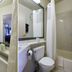 Copley Inn & Suites By OYO Akron Oh bathroom with vanity, toilet, mirror and shower curtain in Copley