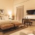 Sant Francesc Hotel Singular guest room in Palma de Mallorca with king bed, desk, TV and bench seating