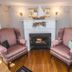Rosewood Country Inn Bradford room with fireplace, sailboat decor and two striped armchairs