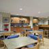 Microtel Inn & Suites by Wyndham Ponchatoula/Hammond breakfast area with tables, chairs and kitchenette