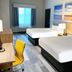 Days Inn & Suites by Wyndham Greater Tomball room with two queen beds, desk, and window in Tomball
