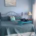 Casa Cielo in Saint Thomas Island bedroom with teal bedspread, matching lamps, and ocean-themed wall art