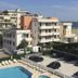 Park Hotel Serena, Rimini: outdoor pool, sun loungers, and sea-view hotel buildings near the coast