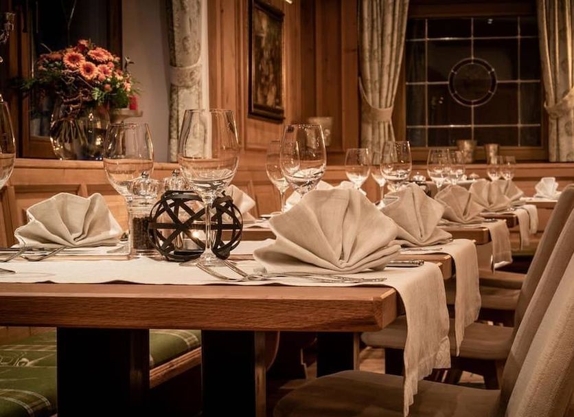 Landhotel Föhrenhof Ellmau dining room with set tables, folded napkins, and wine glasses in Ellmau
