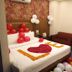 Hotel Grand View in Sylhet room decorated with balloons, rose petals on bed, sofa and vanity