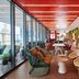 citizenM Miami World Center lounge with colorful seating, floor-to-ceiling windows, and balcony city view in Miami