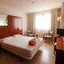 Hotel Balneario Valle del Jerte guest room with double bed, seating area and bright window in Valdastillas