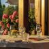 Agriturismo La Sovana in Sarteano, outdoor table set for dining beside flowers and garden views