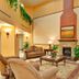 Holiday Inn Express & Suites Beaumont - Oak Valley By IHG lobby with fireplace, sofa seating and coffee table