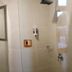Vio Hotel Cimanuk Bandung bathroom with sink, toilet, mirror, shower, and wall-mounted amenities