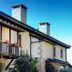 Hotel Balneario Río Pambre in Sambreixo, stone hotel exterior with balcony and chimneys