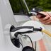 Holiday Inn Express & Suites Cincinnati Ne - Redbank Road By IHG EV charging plug with person holding phone