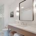 Newport Beach Hotel & Suites bathroom with glass shower, vanity and mirror in Middletown