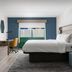 Holiday Inn Express & Suites Drums-Hazleton bedroom with king bed, desk, and window seating