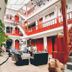 Hotel Choquequirao Cusco courtyard lounge with red balconies, seating, plants, and chandelier
