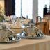Logis Auberge des Vieux Chênes dining room with covered serving dishes on set tables
