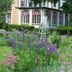 Vintage Gardens Bed & Breakfast in Newark with a lush flower garden beside a historic house