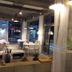 Pohang Youngildae Guesthouse dining area with tables, chairs, and large street-facing windows in Pohang